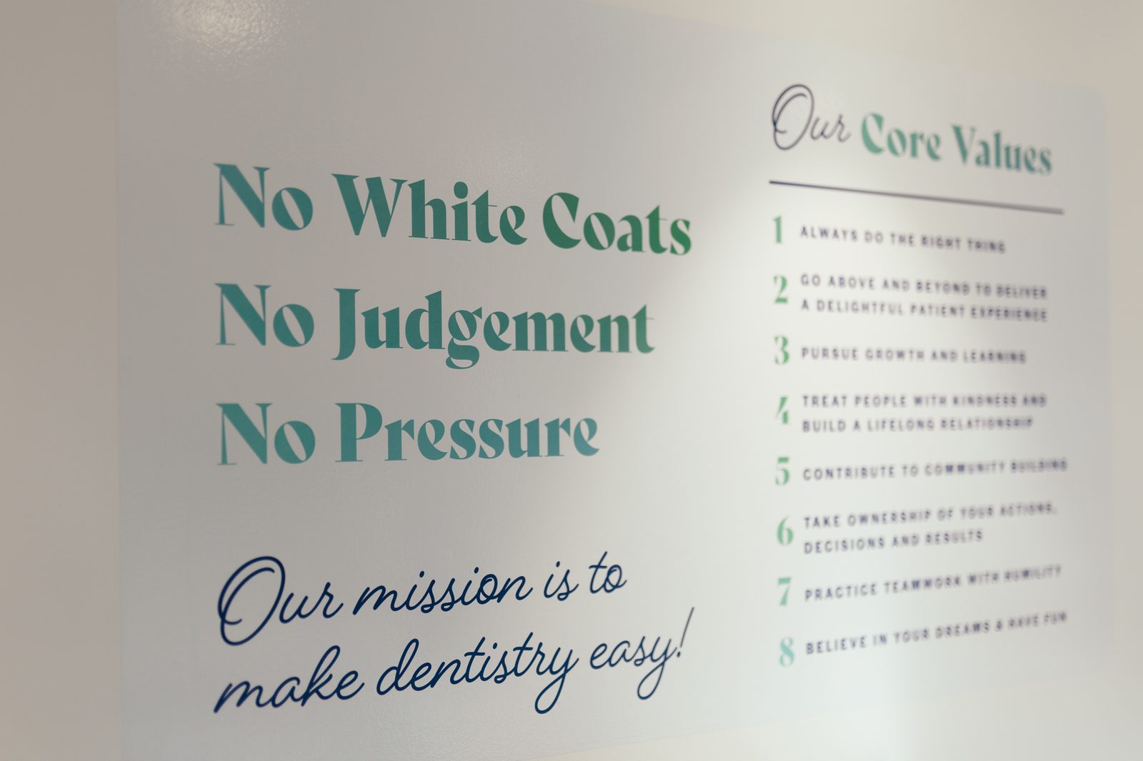 The No White Coats, No Judgement, No Pressure brand wall with the core values list